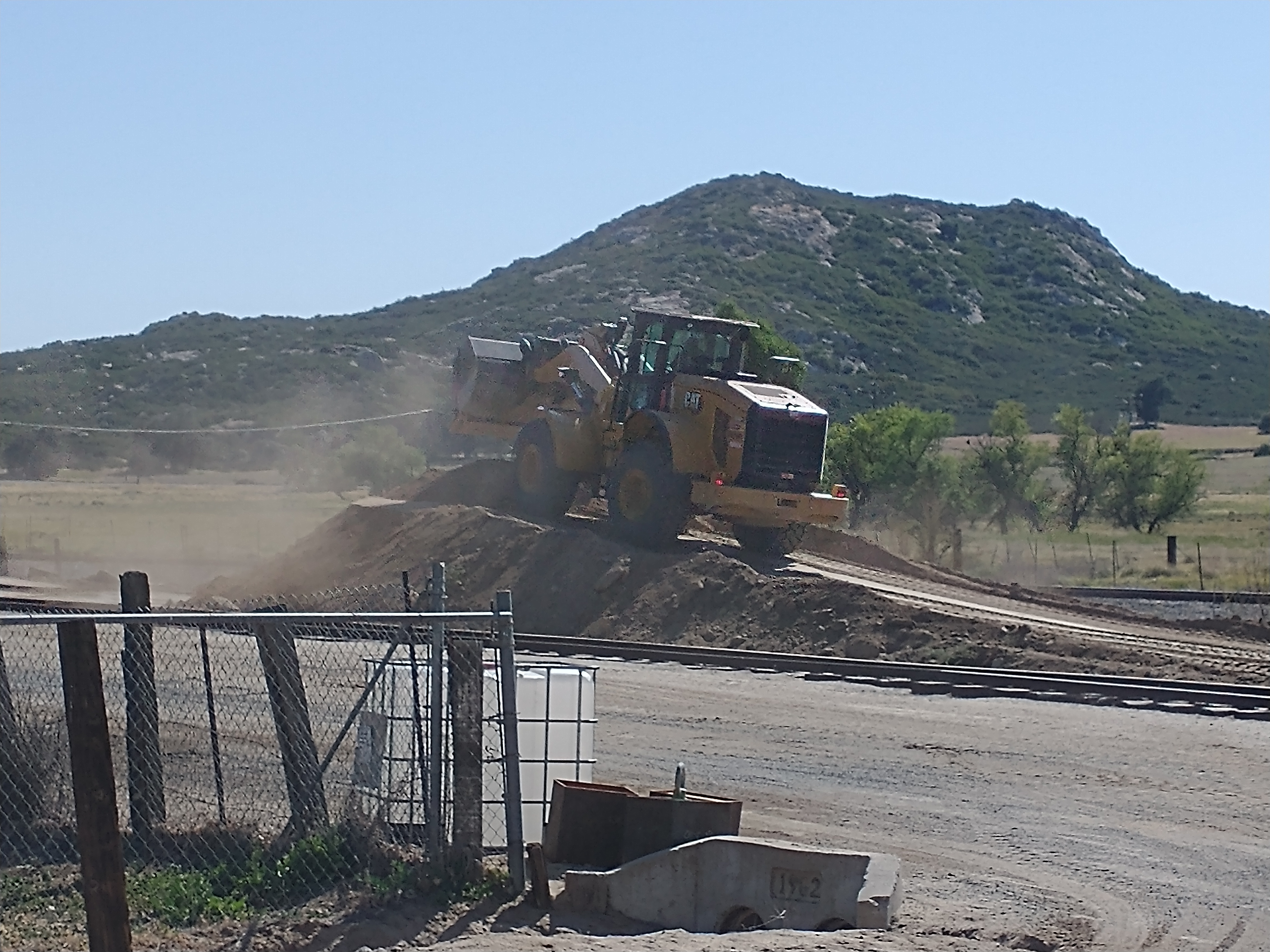 Loader moving dirt during construction of the landing area